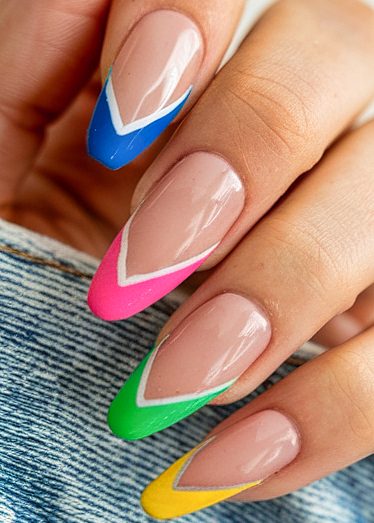 Colorful almond-shaped French tip nails with vibrant designs on a neutral base.