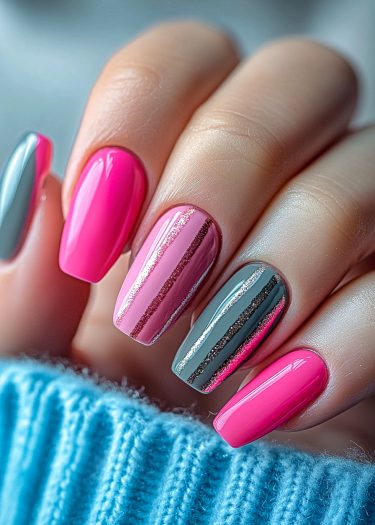 Colorful almond nail art with glossy pink and grey designs for a stylish manicure look.