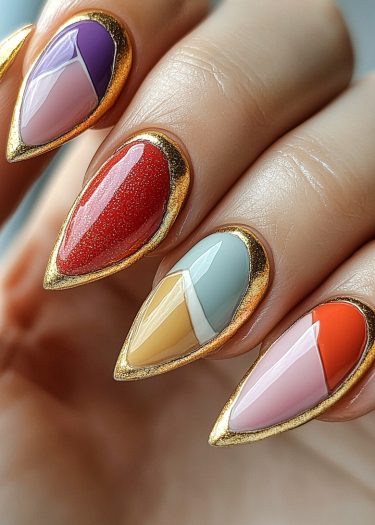 Vibrant almond-shaped nail art featuring geometric patterns and luxurious gold accents.