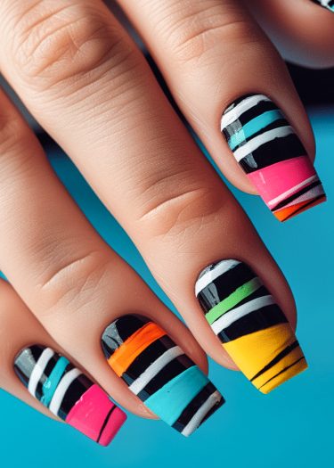 Colorful striped nail art design featuring bold hues against a turquoise background.