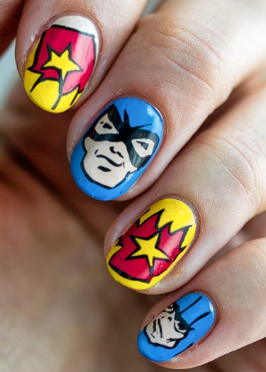 Vibrant comic book nail art featuring superhero faces and dynamic graphic designs.