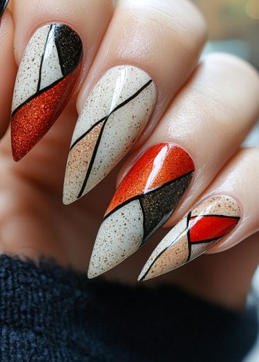 Stylish copper-red stiletto nail art featuring geometric designs and glittery accents.