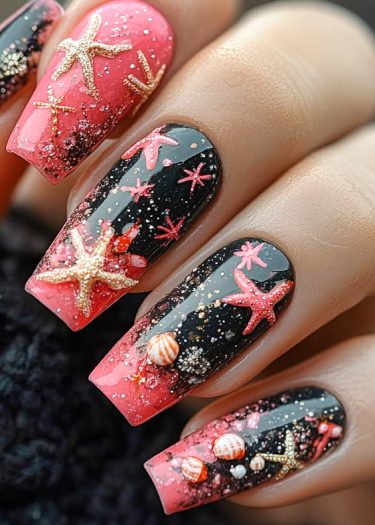 Nautical coral and black gradient nail art with starfish and shell embellishments.