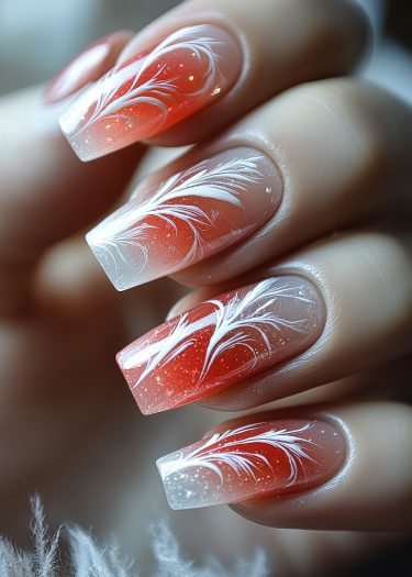 Elegant gradient red and white nail art with delicate feather designs and glossy finish.