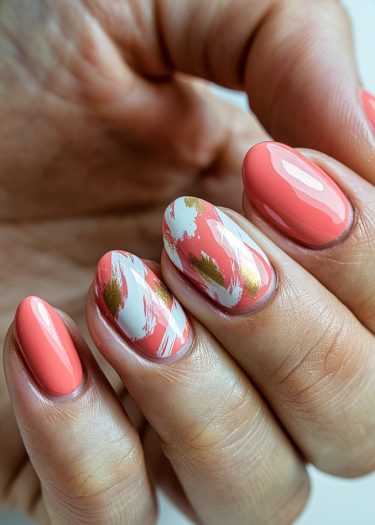 Vibrant coral pink manicure with artistic designs and glossy finish, showcasing modern nail art.