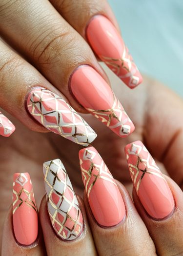 Elegant coral and white almond-shaped nail art with gold geometric patterns.