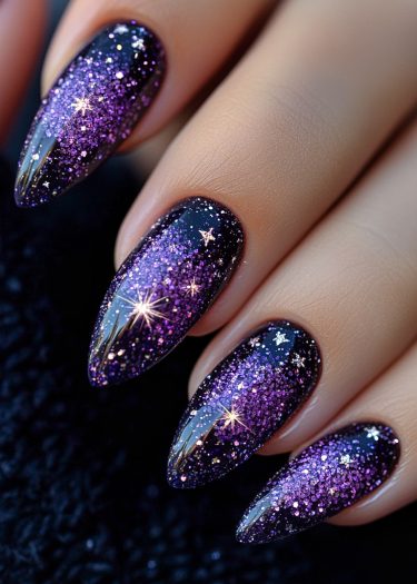 Stunning cosmic galaxy nail art featuring black base, glitter ombre, and star-shaped accents.