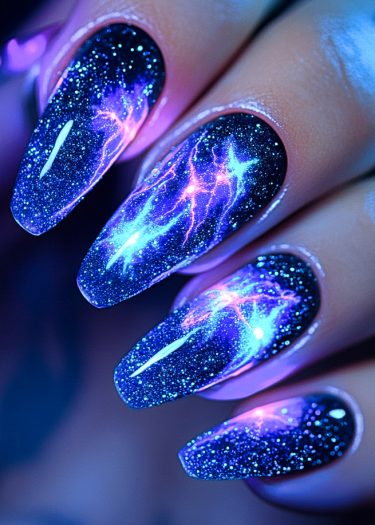 Stunning galaxy-themed nail art with cosmic colors and glittery stars for a mesmerizing look.