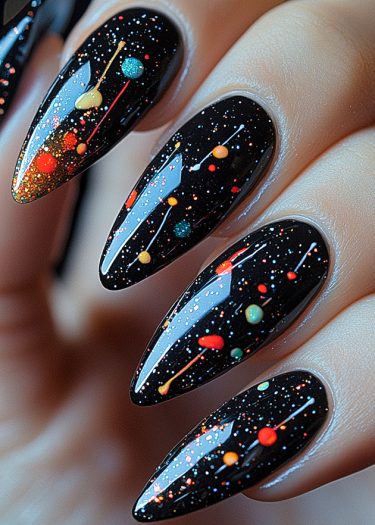 Stunning cosmic nail art with glossy, stiletto-shaped nails depicting a galaxy-inspired design.