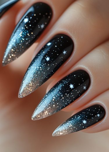 Stunning cosmic nail art featuring a black base, glitter gradient, and intricate star designs.