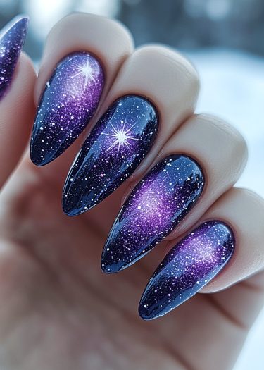 Stunning cosmic nail art featuring a starry night sky in deep purples and blues.