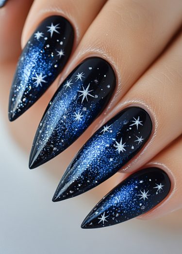 Elegant cosmic night sky nails with glittering stars on a glossy black base.