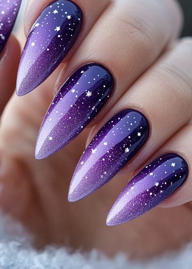 Stunning cosmic purple ombre nails with starry design for a celestial nail art look.