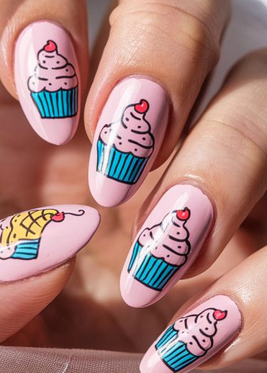 Beautiful cupcake nail art with pink polish, whimsical designs, and vibrant colors.