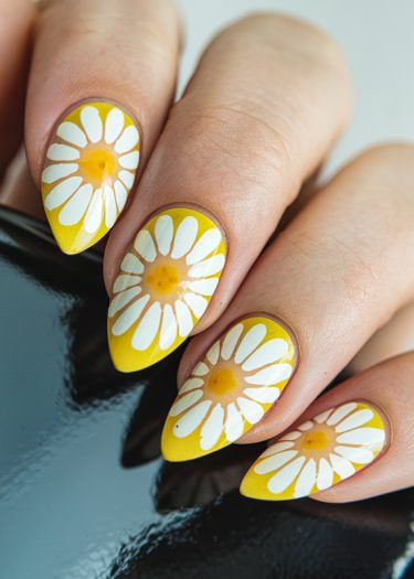 Vibrant daisy nail art on almond-shaped nails with glossy finish and intricate floral designs.