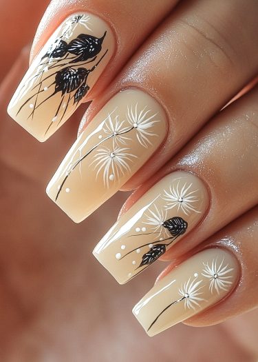 Elegant dandelion nail art design on long square nails with a soft beige background.