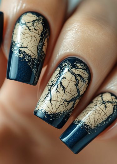 Elegant navy blue and beige nail art with intricate designs on long, glossy nails.