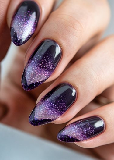 Elegant dark purple almond nails with glitter gradient art for a glamorous manicure.