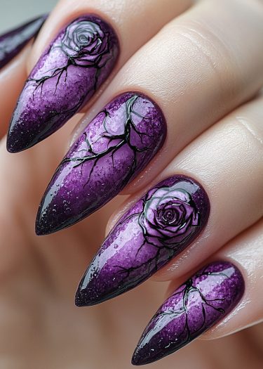 Elegant dark purple rose nail art with intricate ombre and branch designs on stiletto nails.