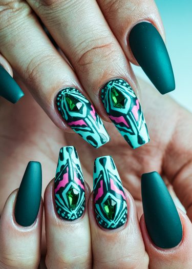 Elegant dark teal almond nails with geometric art and green gems for a modern look.