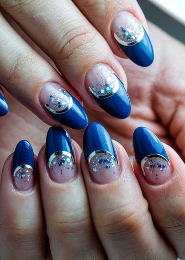 Elegant deep blue French manicure with glitter accents and metallic details for a glamorous look.