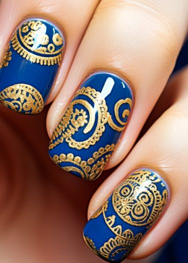 Elegant deep blue and gold intricate nail art design showcasing sophisticated patterns and luxury.