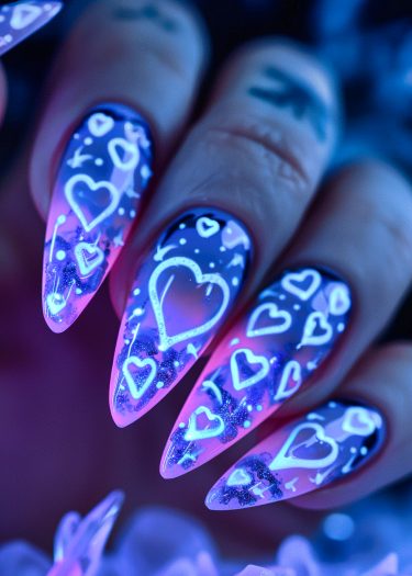 Vibrant purple and pink heart nail art with glowing accents and celestial motifs.