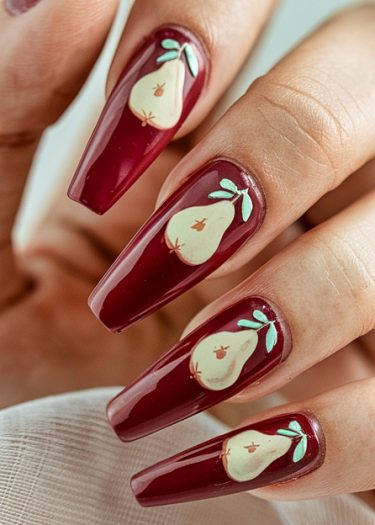 Elegant deep burgundy nails with stylish pear nail art and glossy finish.