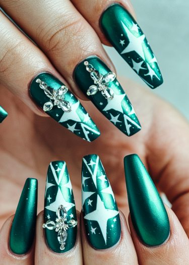 Elegant deep green stiletto nails with star motifs and sparkling jeweled accents.