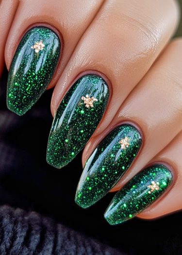 Elegant almond-shaped nails with deep green glitter and gold floral design for stylish manicures.