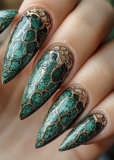 Chic deep green and gold reptile scale nail art on long almond-shaped nails.