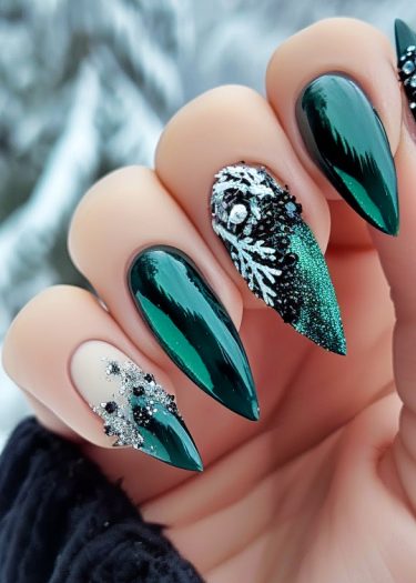 Elegant deep green nail art with intricate silver accents, perfect for winter fashion.