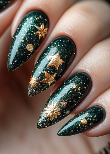 Elegant deep green stiletto nails with gold celestial designs and shimmering glitter finish.