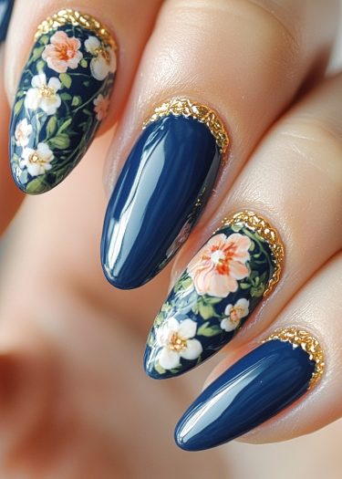 Elegant navy almond nails with floral designs and gold accents for a luxurious manicure.