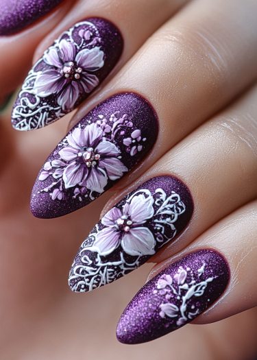 Elegant deep purple nails with 3D floral designs and intricate white swirls.