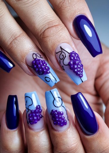 Vibrant deep purple and light blue grape nail art showcasing intricate 3D designs.