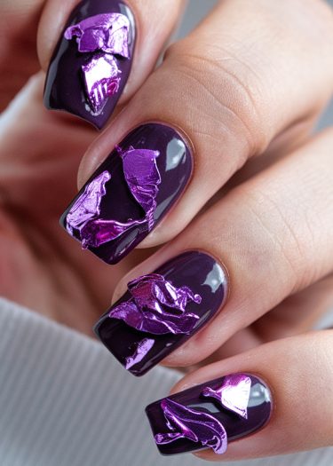 Elegant dark purple nails embellished with metallic pink foil in a modern abstract design.