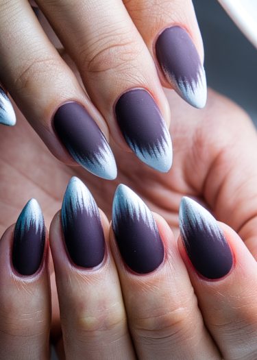 Elegant almond-shaped deep purple ombre nails with a matte finish.