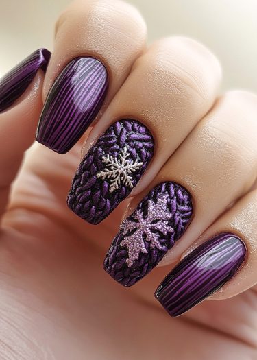 Elegant deep purple nails with snowflake designs and glossy finishes for winter nail art.