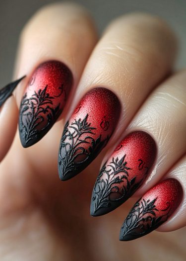 Elegant stiletto nails with a deep red to black gradient and intricate lace designs.