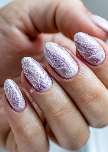 Elegant almond-shaped nails featuring intricate pink and lavender lace nail art design.