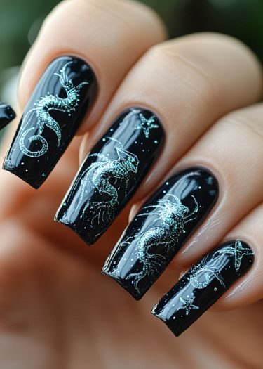 Elegant black nail art featuring intricate silvery-blue dragon designs and celestial stars.