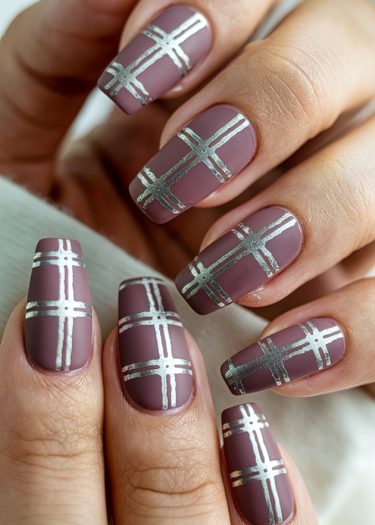 Elegant dusty mauve nails with silver metallic grid design for a chic manicure look.