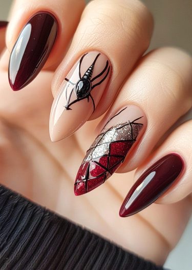 Stunning stiletto nail art with burgundy, spider design, and geometric patterns for a bold look.