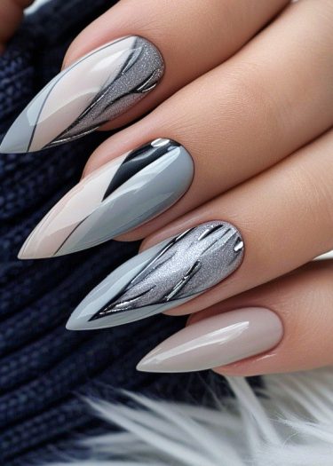 Elegant almond nail art featuring intricate gray, silver, and nude designs with a glossy finish.