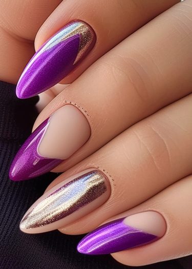 Stylish almond-shaped nails featuring metallic purple and gold French tips with intricate detailing.