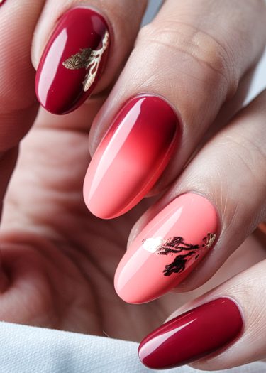 Elegant almond-shaped nails featuring red and pink gradients with gold leaf designs.