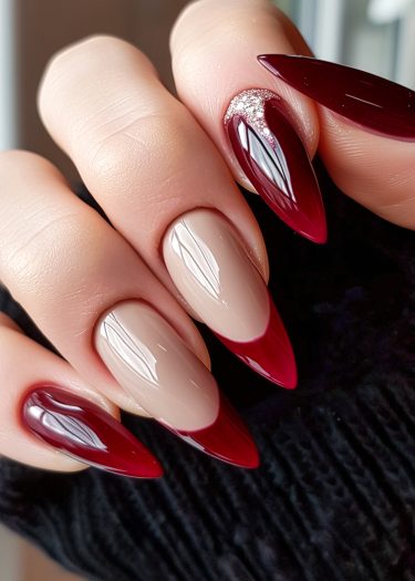 Elegant almond-shaped nails with burgundy tips and sparkling rhinestones for a sophisticated manicure.