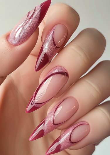 Elegant almond nails with intricate pink designs and a glossy burgundy base.