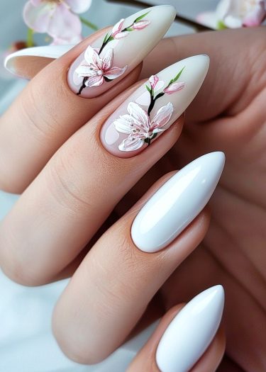 Elegant almond-shaped nails with floral designs in soft pink and white hues.